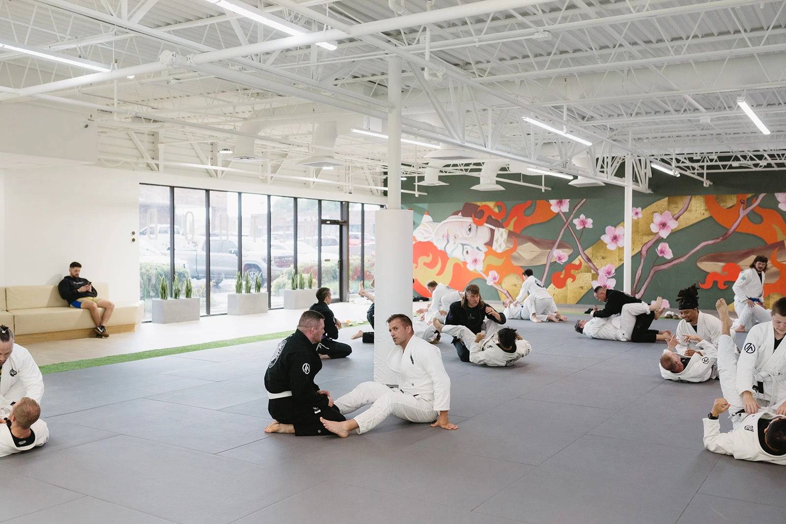 Adult students drilling jiu-jitsu techniques on the mats at Method Jiu-Jitsu in Tulsa