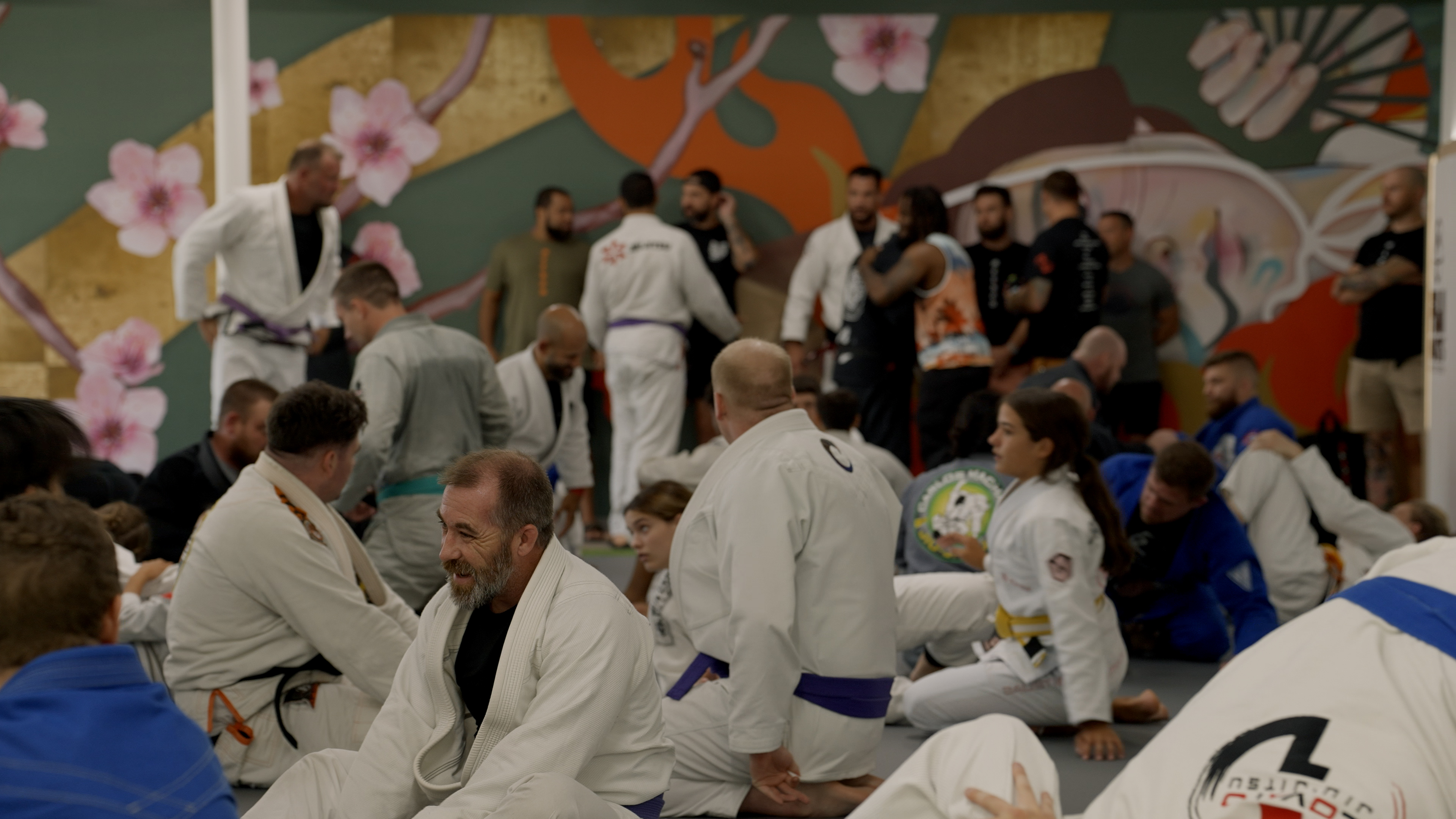 Packed mat room during jiu jitsu class at Method Jiu Jitsu in Tulsa Oklahoma showing community of training partners