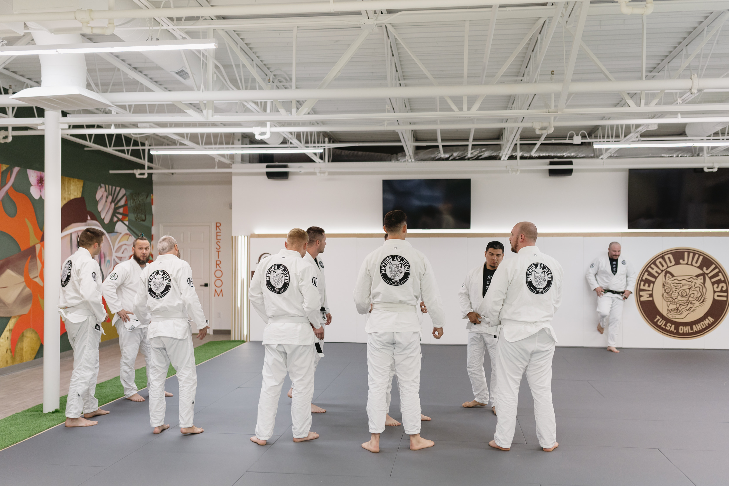 Method Jiu-Jitsu students in white gis gathering on the training mats for technical practice in Tulsa